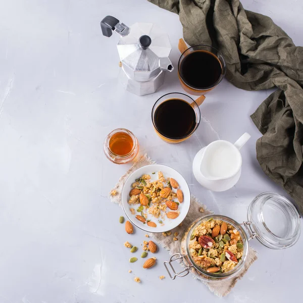Breakfast with black coffee muesli granola honey nuts milk — Stock Photo, Image
