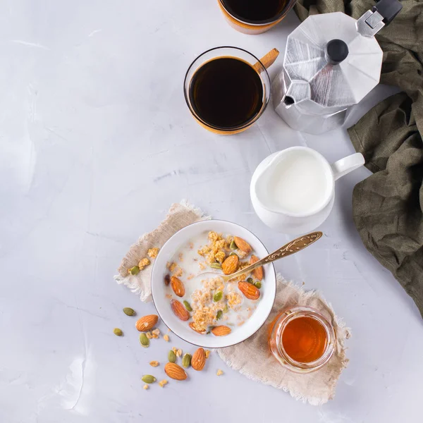 Breakfast with black coffee muesli granola honey nuts milk — Stock Photo, Image