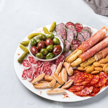 Natürmort, gıda ve içecek, tatil kavramı. İspanyolca tapas veya İtalyan antipasti et, salam, zeytin, peynir, fındık ve bir masada ekmek