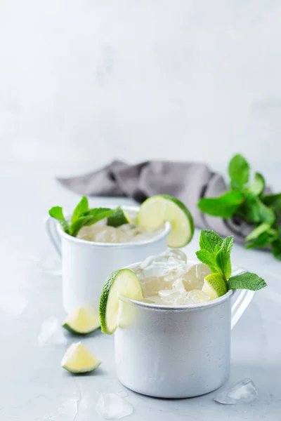 Food and drink, holidays party concept. Cold fresh classic beverage moscow mule cocktail in a silver mug with vodka, ginger beer. lime and mint for refreshment in summer days. Copy space background