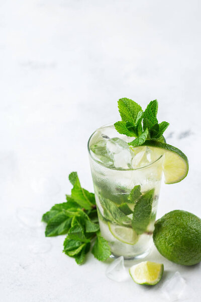 Classic alcohol cocktail mojito with rum, soda, lime and mint
