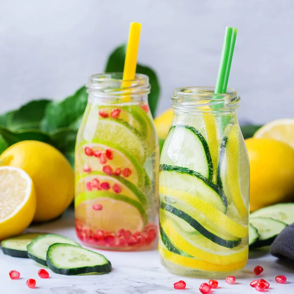 Health care, fitness, healthy nutrition diet concept. Fresh cool lemon cucumber rosemary pomegranate infused water, detox drink, lemonade in a glass jar for spring summer days.