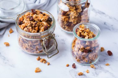 Healthy clean eating, dieting and nutrition, fitness, balanced food, breakfast concept. Homemade granola muesli with ingredients on a table clipart
