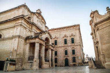 Valletta, Malta şehir manzarası. Valletta 'daki Dar Sokak - Malta' nın başkenti. Geleneksel Malta mimarisi. La Valetta 'nın eski tarihi parçası. Dışarıda insanlar ve dar sokaklar, Malta.
