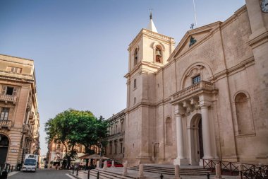 Valletta, Malta şehir manzarası. Valletta 'daki Dar Sokak - Malta' nın başkenti. Geleneksel Malta mimarisi. La Valetta 'nın eski tarihi parçası. Dışarıda insanlar ve dar sokaklar, Malta.