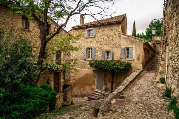 French medieval town in Provence - Gordes. Beautiful panoramic view on medieval town Gordes. Old street of Gordes, a small typical town in Provence, France. Beautiful village, with view on roof and landscape