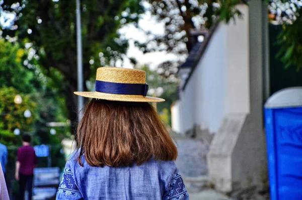 people, summer holidays, travel, tourism and vacation concept - woman in swimsuit and sun hat from back over dubai city background