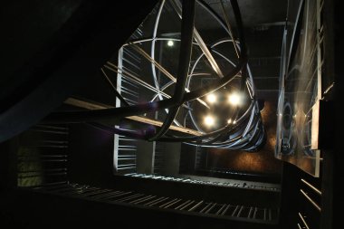 The elevator with bright lanterns moves in an openwork design