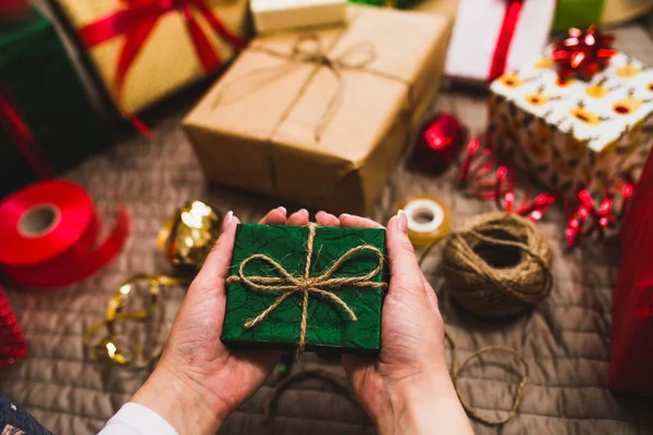 Gift wrapping, woman packing holiday gifts at home