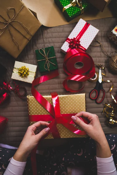Gift wrapping, woman packing holiday gifts at home