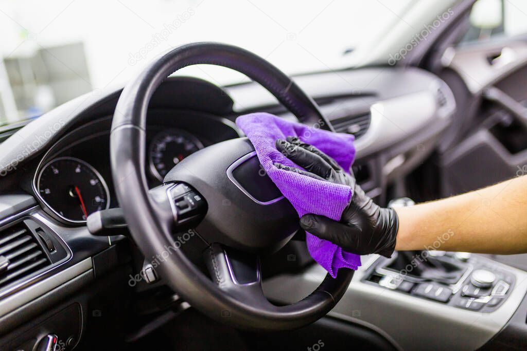 close up of man cleaning car interior, car detailing concept. Selective focus. 