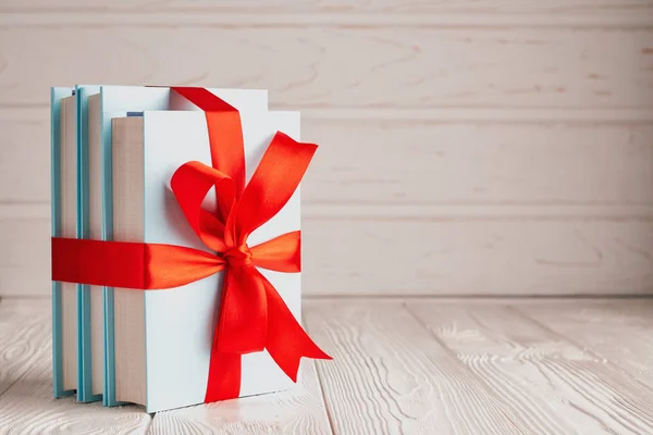 Books tied with a ribbon with place for text: the concept of a good book is a good gift