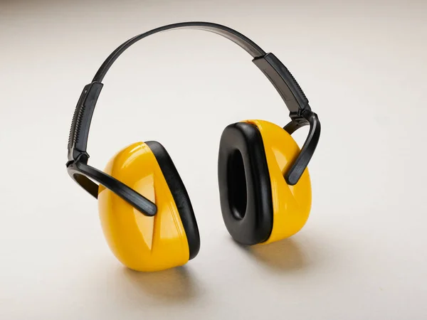 Headphones to protect hearing from noise on a light background.