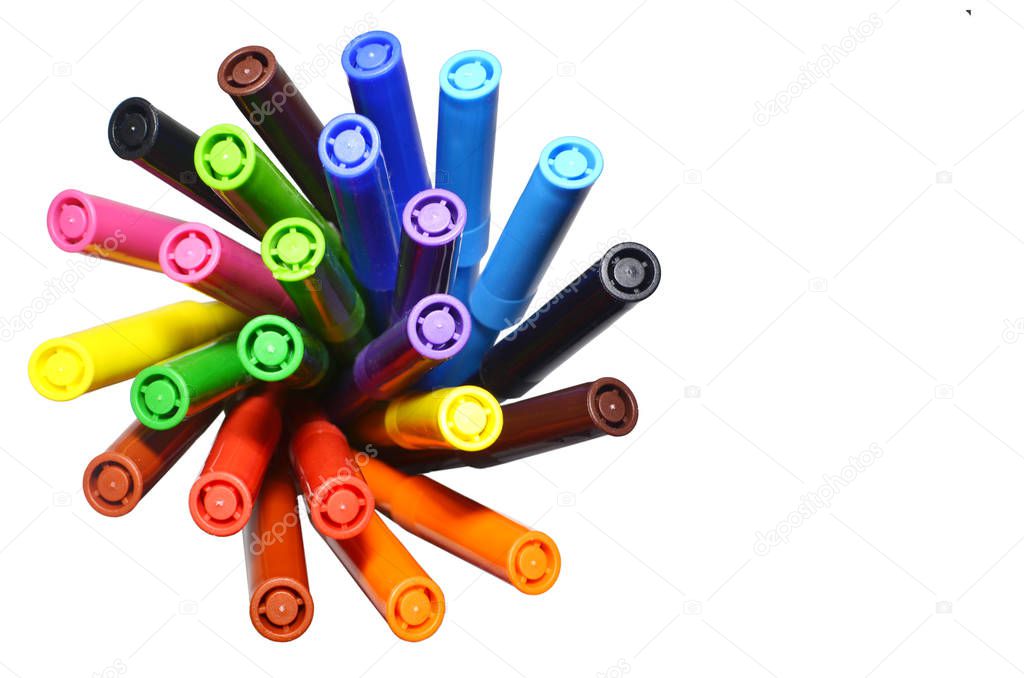 multi-colored felt-tip pens on the white isolated background. Top view. Selective focus