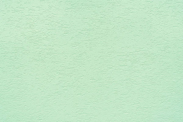 Texture of concrete wall covered with decorative stucco with a rough surface and neon mint color cracks. The concept of the structure, texture, decor.