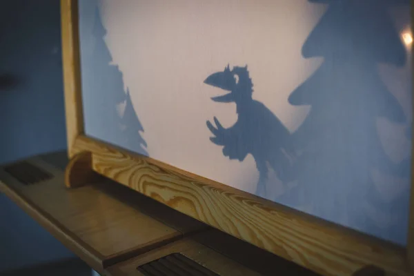 teacher do a shadow play crow in kindergarten or preschool. child play concept shadow pantomime shadowgraph for children