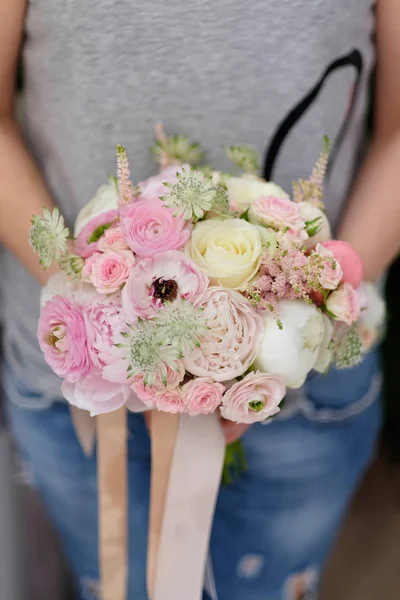 Bride bouquet for wedding event. Woman hold in his hands a wedding bouquet.