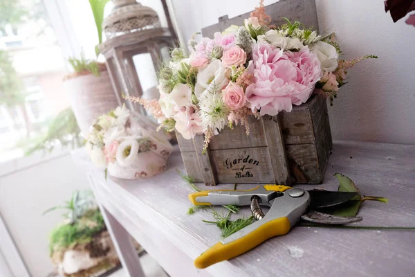 Bouquets of roses for special events. Beautiful floral arrangements for special events inside florist shop.