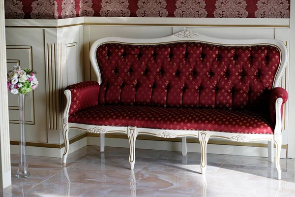 Vintage red sofa. Luxury interior with a red sofa in guest reception room.