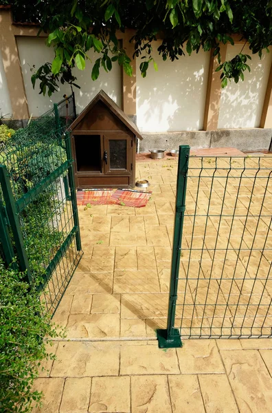 Dog house. Dog house with private space for dogs near the house stone fence.