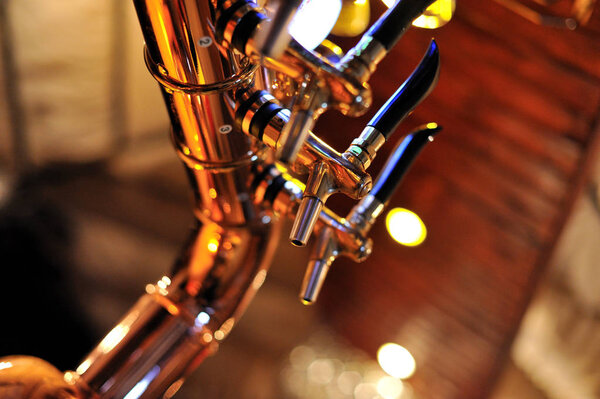 Golden beer taps. Beer taps system from the tap bar.