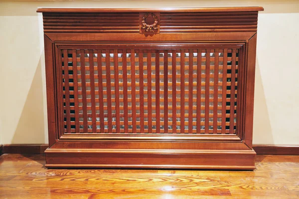Radiator wood cabinet. Elegant furniture for rooms. Wooden mask for radiators with elegant design.