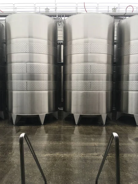 Wine fermentation tanks. New modern wine fermentation tanks in the factory courtyard.