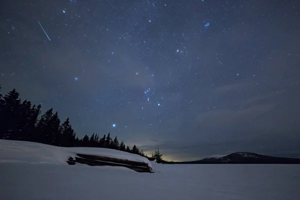 Inverted boat in winter against a starry sky