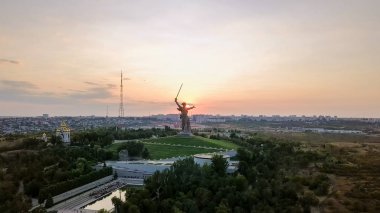 In the light of the setting sun. Sculpture The Motherland Calls! - the compositional center of the monument-ensemble to the Heroes of the Battle of Stalingrad on the Mamayev Kurgan! Volgograd, Russia  clipart