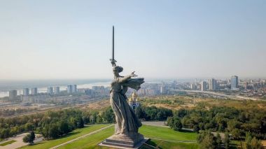Sculpture The Motherland Calls! - compositional center of  monument-ensemble to Heroes of Battle of Stalingrad on Mamayev Kurgan. Early morning. Volgograd, Russia  clipart