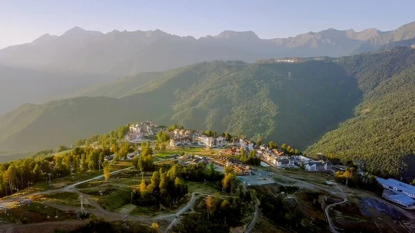 Rosa Khutor Yaylası, binalar, yamaçları ve sandalye asansörleri. Gün batımında havadan görünümü 