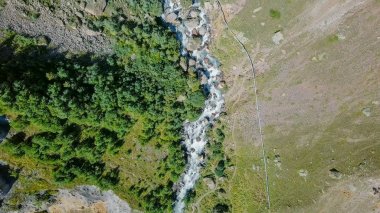 Elbrus from the north. The Sultan waterfall on the Kyzyl-Su river. Aerial view. Kabardino-Balkaria, Russia  clipart