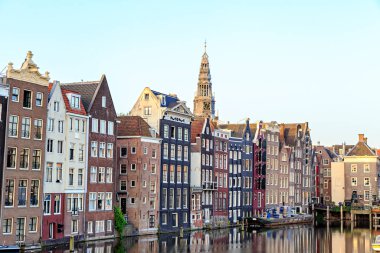 Old houses of the city. Damrak Canal houses in the early morning