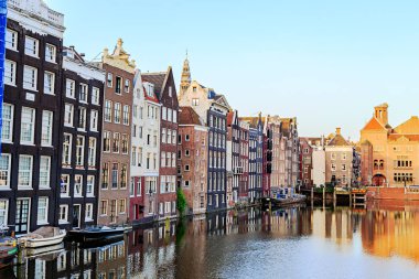 Old houses of the city. Damrak Canal houses in the early morning