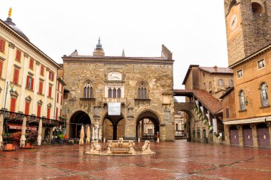 Bergamo, Italy - July 15, 2019: Vecchia Square with fountain. The historical part of the city. Rainy weather