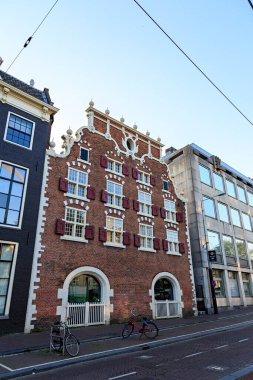 Amsterdam, Netherlands - June 30, 2019: The historic city center. Old houses of the city. House on Street (Canal) Singel