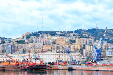 Genoa, Italy - July 11, 2019: Fire boat in the port of Genoa. City view