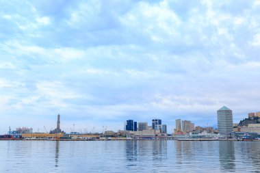Genoa, Italy - July 11, 2019: Panorama of the port of Genoa in the early morning. Lighthouse