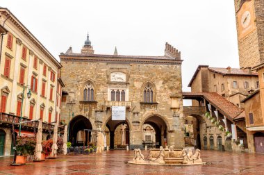 Bergamo, Italy - July 15, 2019: Vecchia Square with fountain. The historical part of the city. Rainy weather