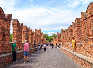 Verona, Italy - July 15, 2019: Bridge Castelvecchio (Old Castle) with tourists. The castle was built between 1354 and 1376