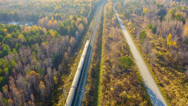 Russia, Ural, Yekaterinburg. Railway train with wagons. Electrified Railway. Highway. Sunset light, Aerial View