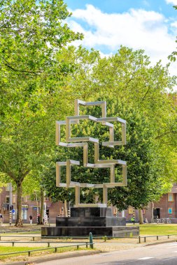 Rotterdam, Netherlands - July 1, 2019: Taxat (2004) Woody van Amen. is a stainless steel sculpture representing a spatial translation of the double cross (mathematical form)
