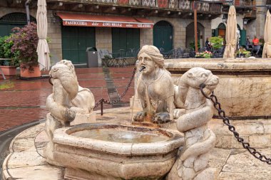 Bergamo, Italy - July 15, 2019: Antique Drinking Fountain on Vecchia Square. The historical part of the city. Rainy weather