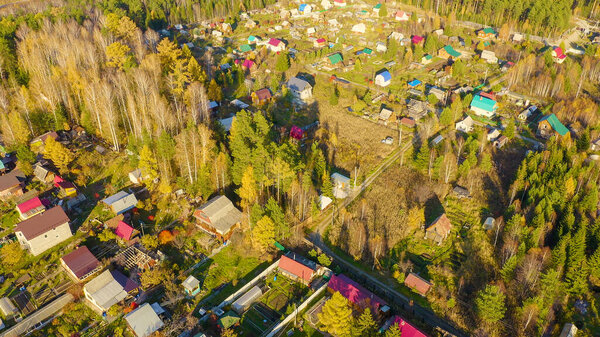 Holiday village in the suburbs of the city of Ekaterinburg. Ural, Russia. Autumn, sunset time, Aerial View