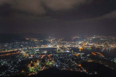Nagasaki şehri geceleri aydınlanıyor. Inasa Dağı 'nın gözlem platformundan Panorama gece manzarası. Dünyanın en ünlü güzellik manzaralı yeri, 10 milyon dolarlık gece gösterimi. Nagasaki Bölgesi, Japonya