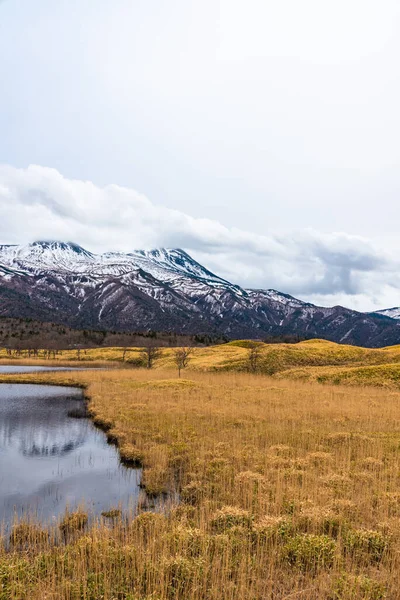 Beautiful lake and rolling mountain range on springtime sunny day. High latitude country natural beauty scenery. The First Lake of Shiretoko Goko Five Lakes, Shiretoko National Park. Hokkaido, Japan