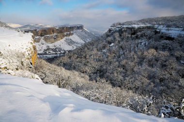 The Kachi-Kalion cave monastery view from the Crimean Kyzyl-Burun mountain in winter clipart