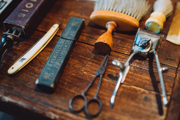 Vintage tools of barber shop on light wooden background