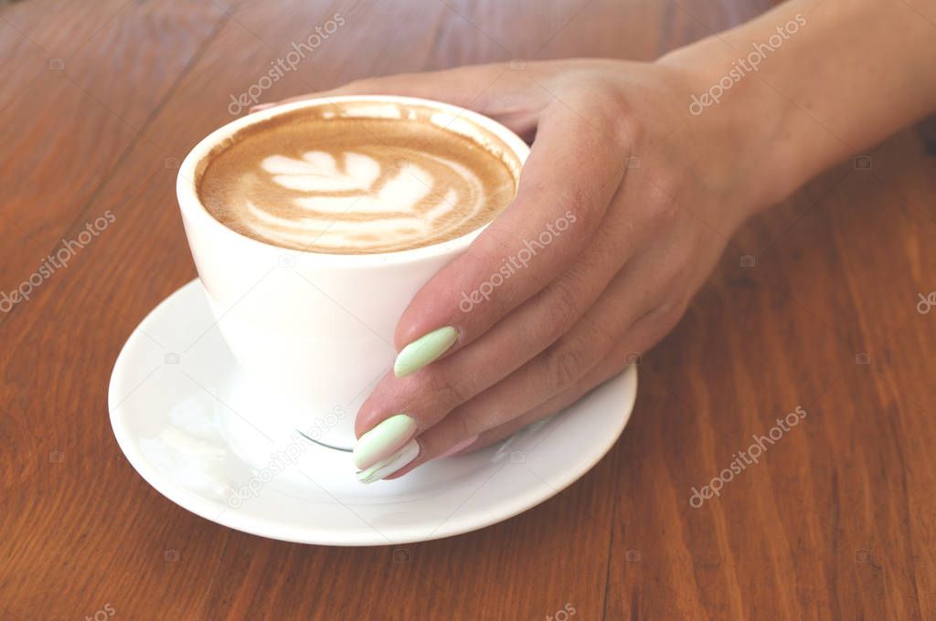 Close up of of coffee cup and hands.