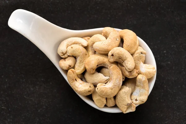 Cashew nuts on dark slate background — Stock Photo, Image